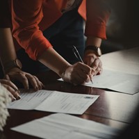 Signing documents on table